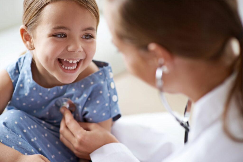 Child smiling during a doctor’s examination