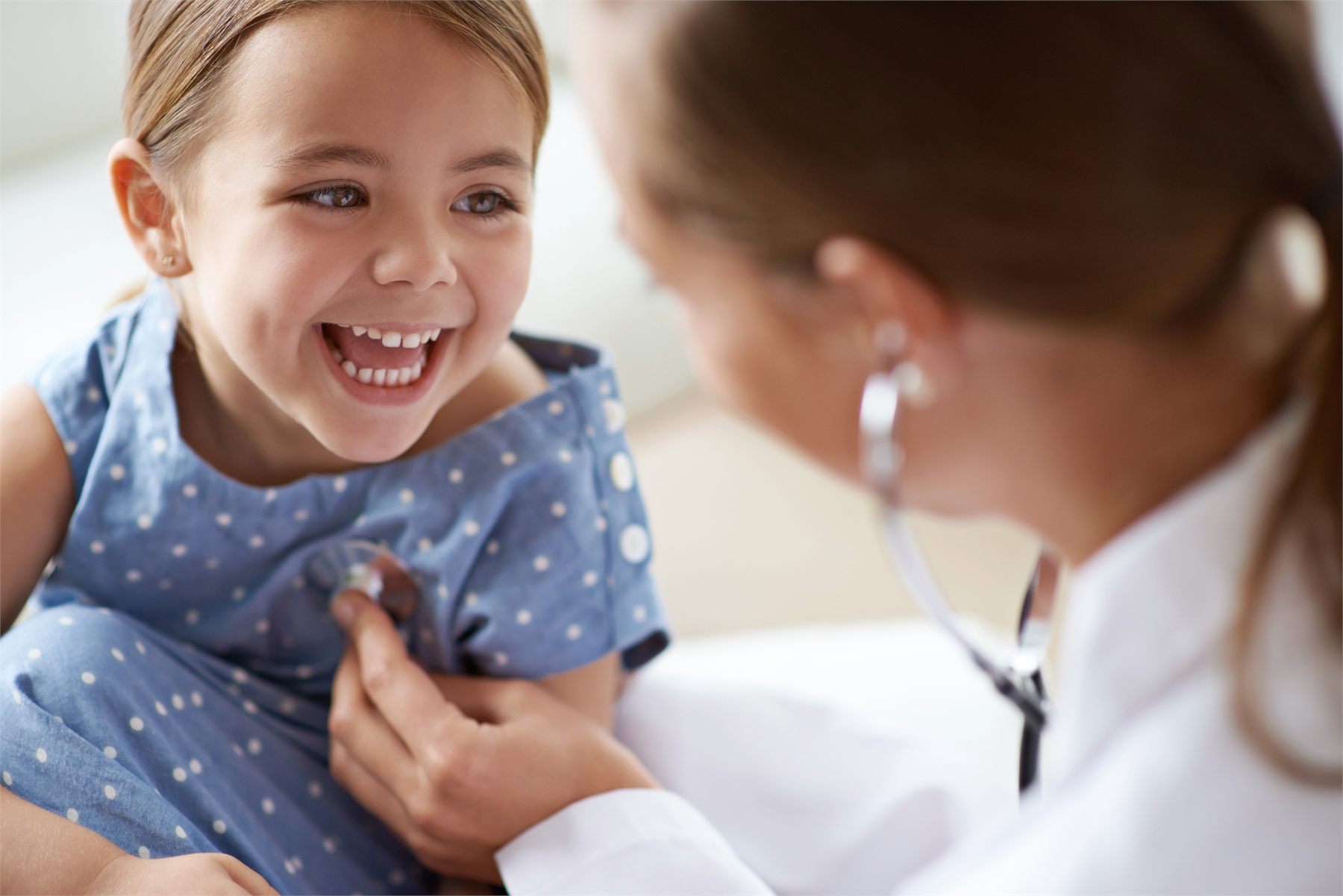 Child smiling during a doctor’s examination